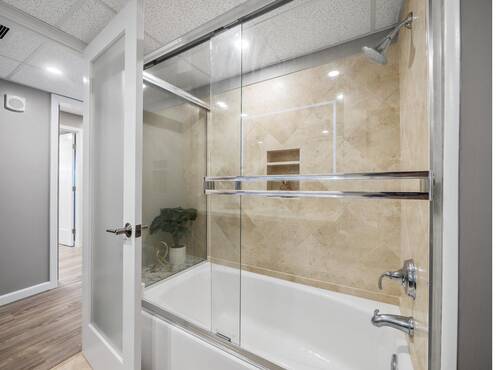 Bathtub with glass enclosure